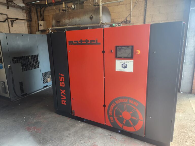 Large industrial air compressor system installed in plant room for high-demand compressed air