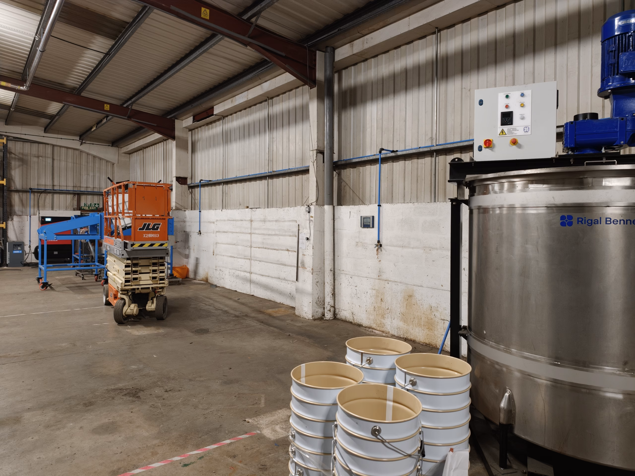 Blue 25 mm AirNet compressed air pipework along the production area wall in Droitwich